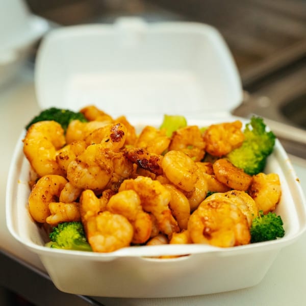 Tokyo Express Grill's shrimp and broccoli dish in a white takeout container.