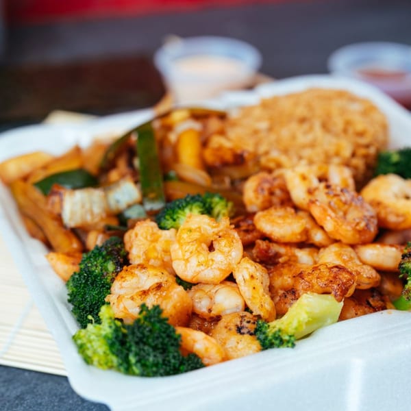 Tokyo Express Grill's shrimp and broccoli hibachi with fried rice and vegetables in a takeout container.