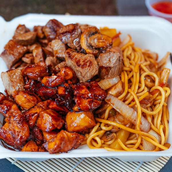 Tokyo Express Grill's chicken and steak teriyaki with noodles and vegetables in a takeout container.