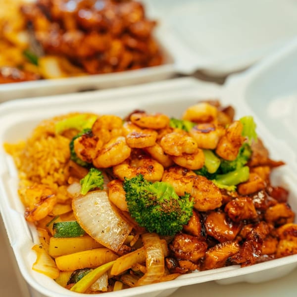Tokyo Express Grill's shrimp, chicken, rice, and vegetables in a takeout container.